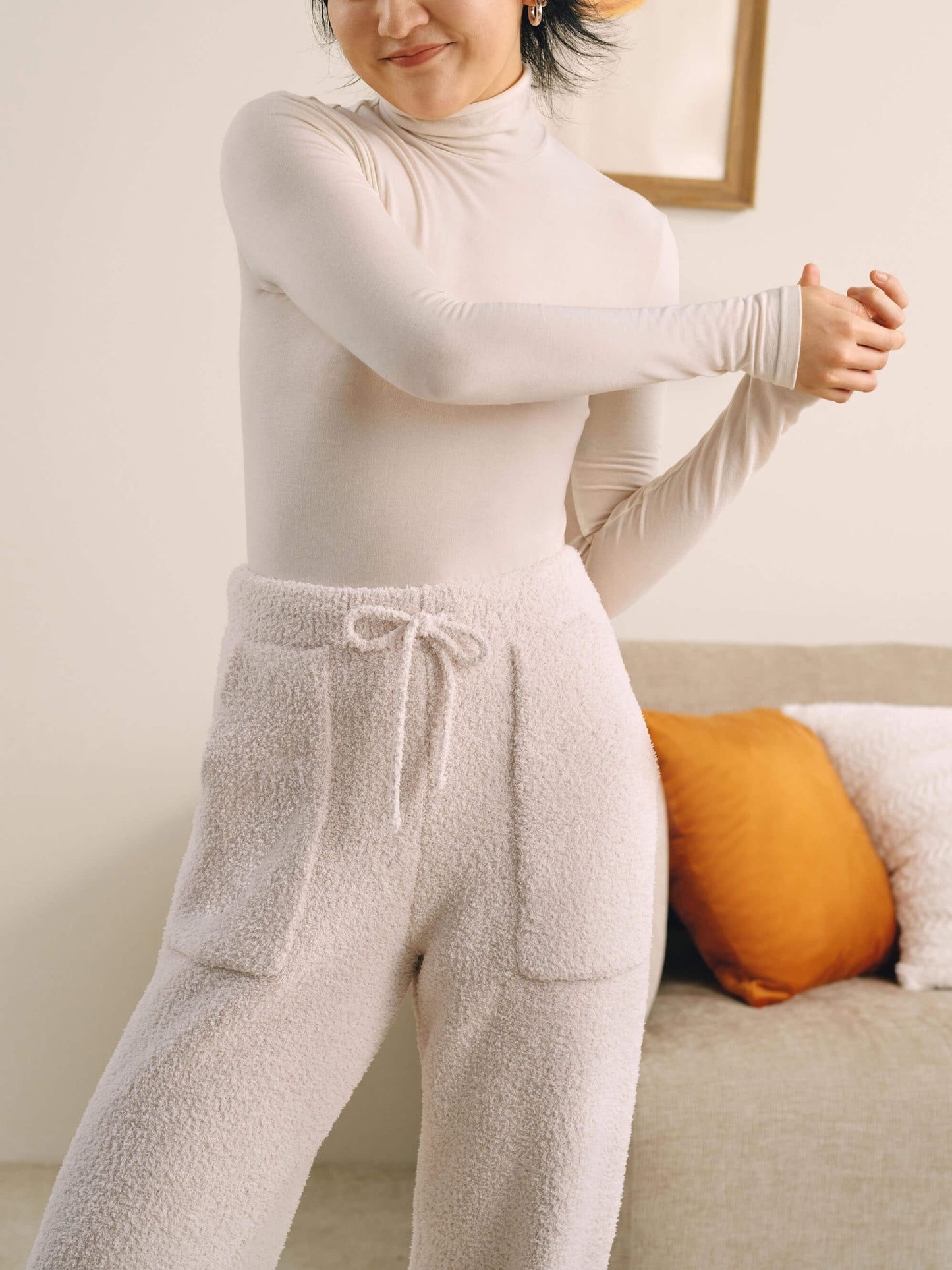 Front view of woman wearing white wool seamless turtleneck