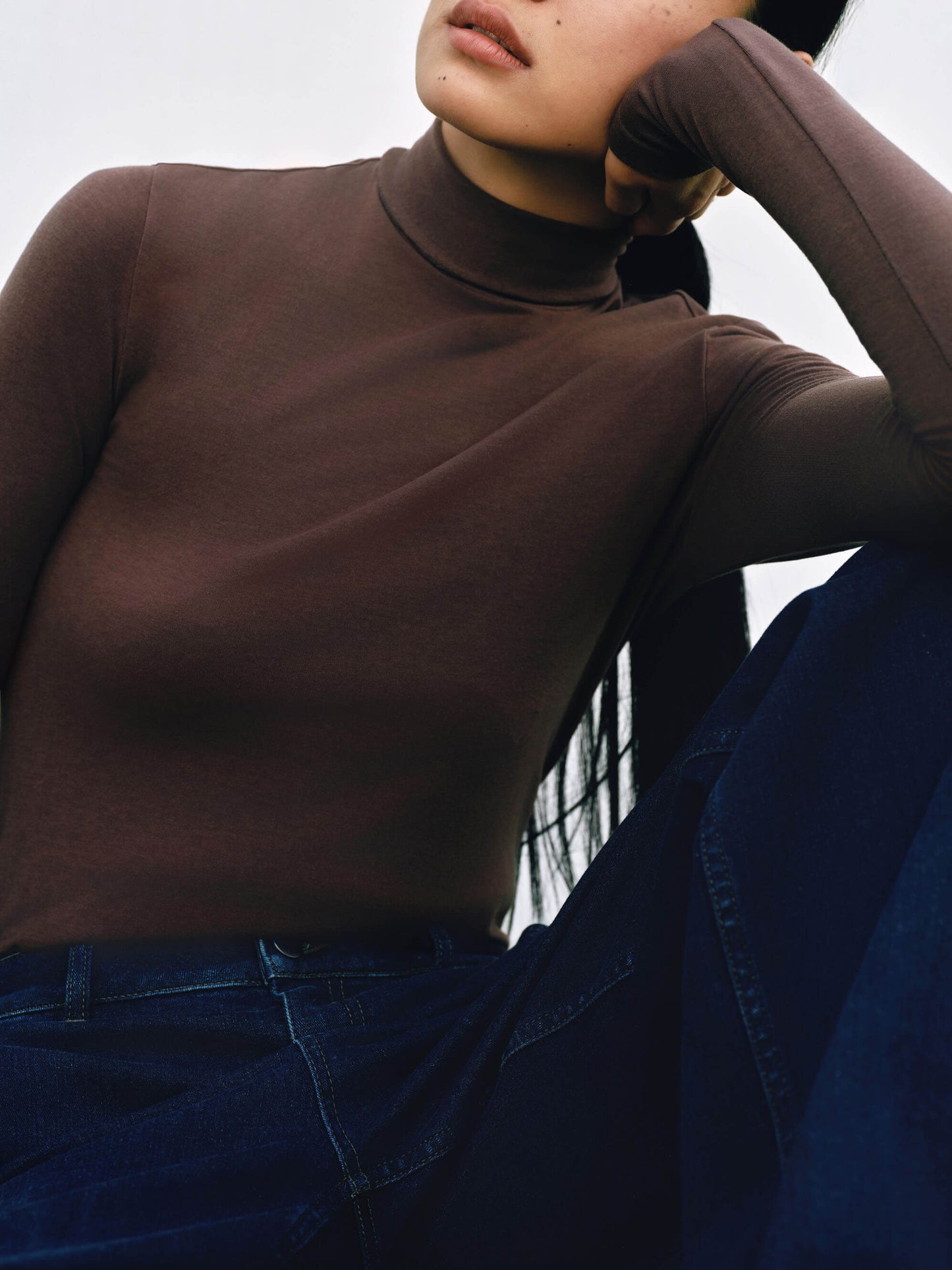 Fabric detail of woman wearing brown wool turtleneck