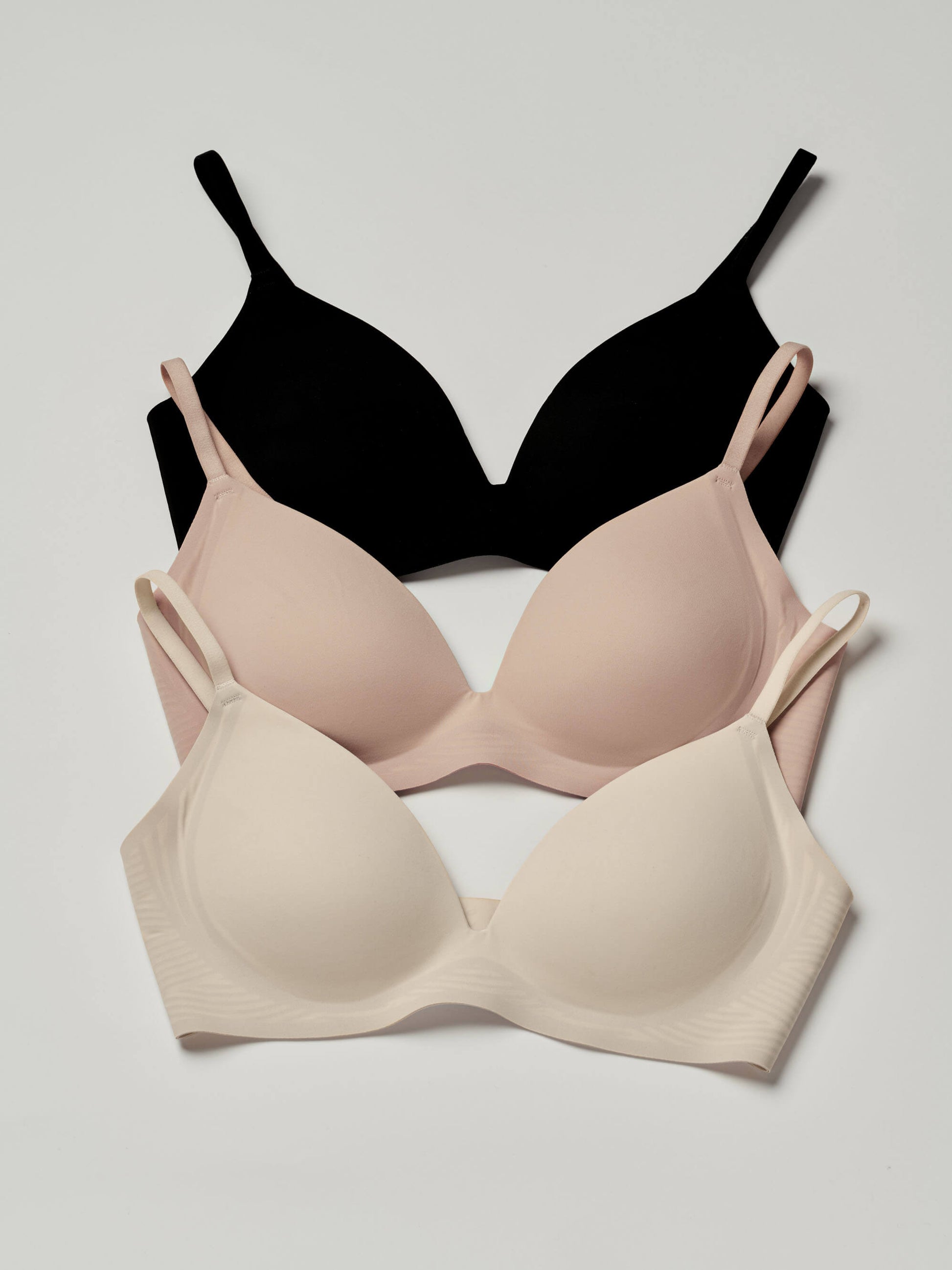 Trio of black, nude, and white bra.