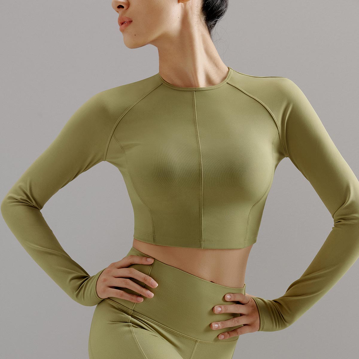 Woman wearing green activewear shirt and leggings