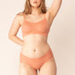 woman in grapefruit color bra and brief