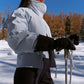 woman in blue down jacket skiing