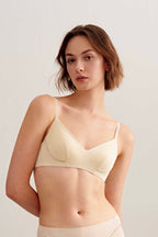a woman wearing light beige bra and brief.