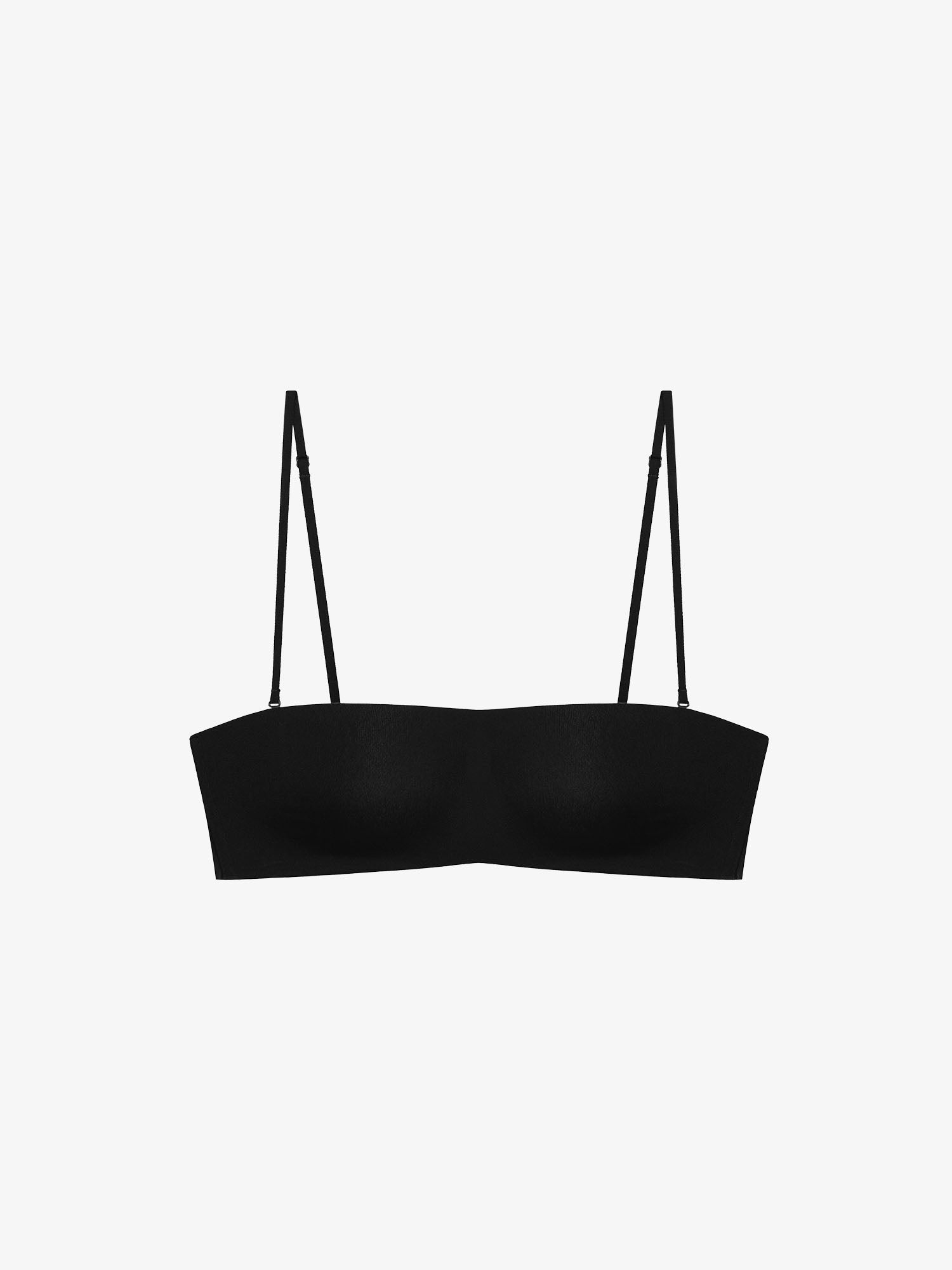 Flatlay of black strapless bra on a white background.