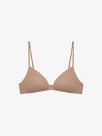 Flat lay of beige bra on a light gray background.