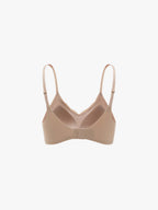 Beige bra on a light beige background. Treacly Almond color.