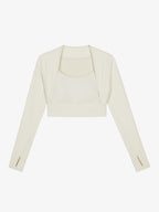 Flat lay of white cropped long sleeve top.