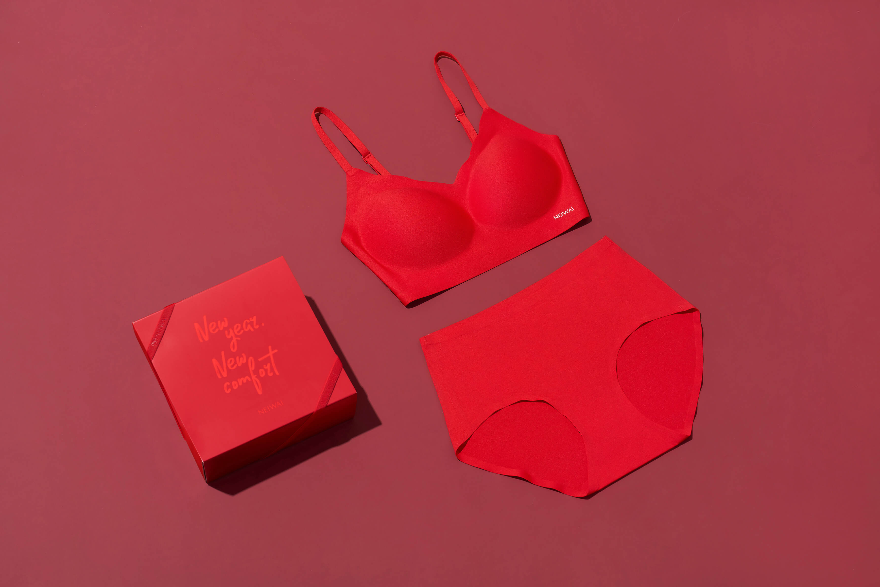 a red bra, a red brief  and a red gift box