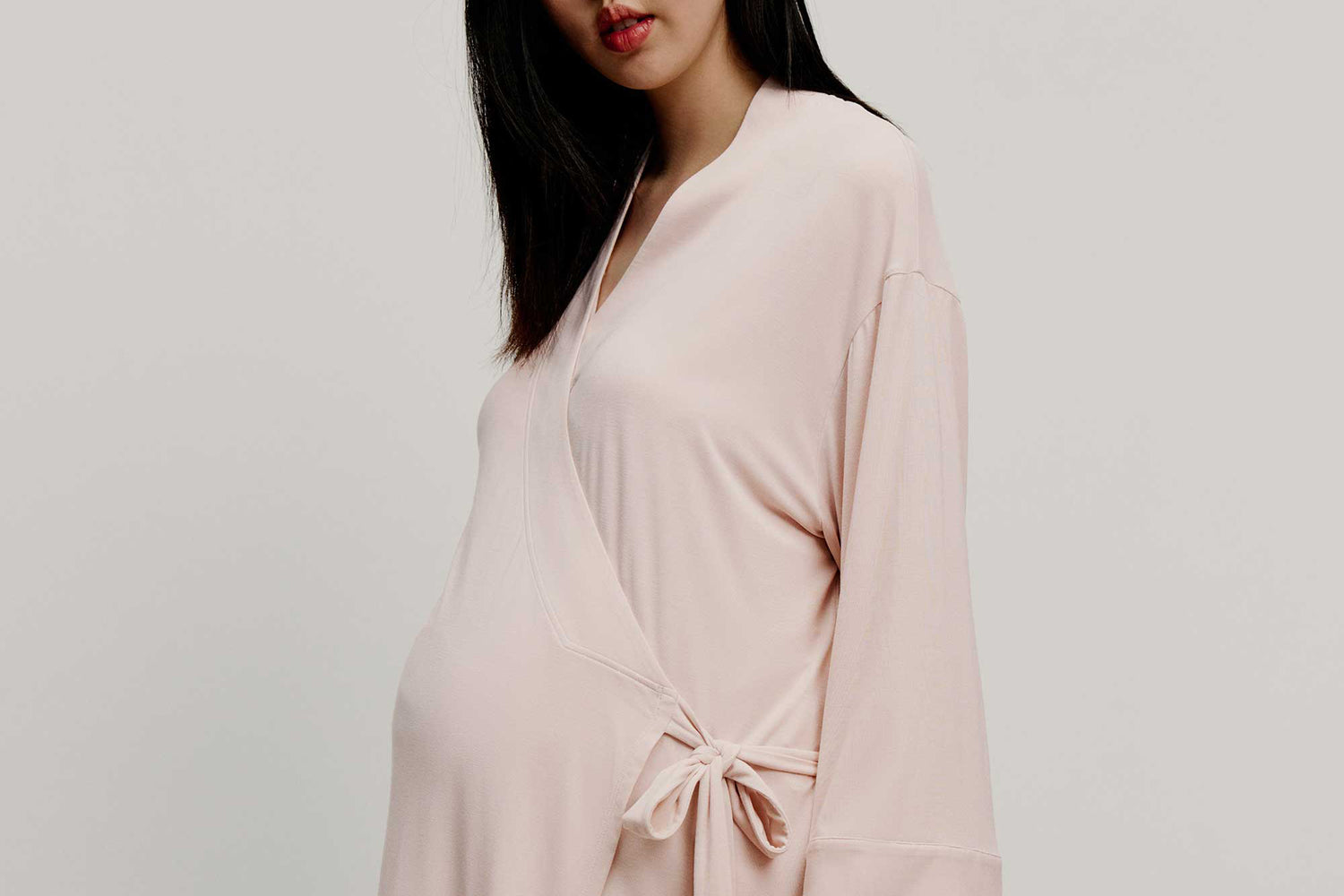 Pregnant woman wearing pink wrap top