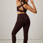 back of woman in brown sports bra and leggings