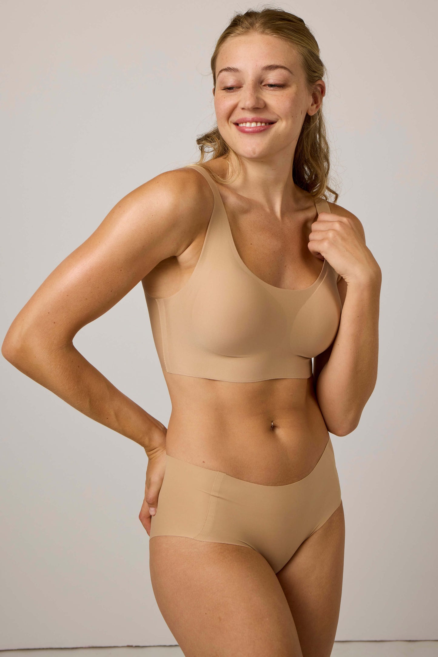 Woman wearing tan bra and matching underwear