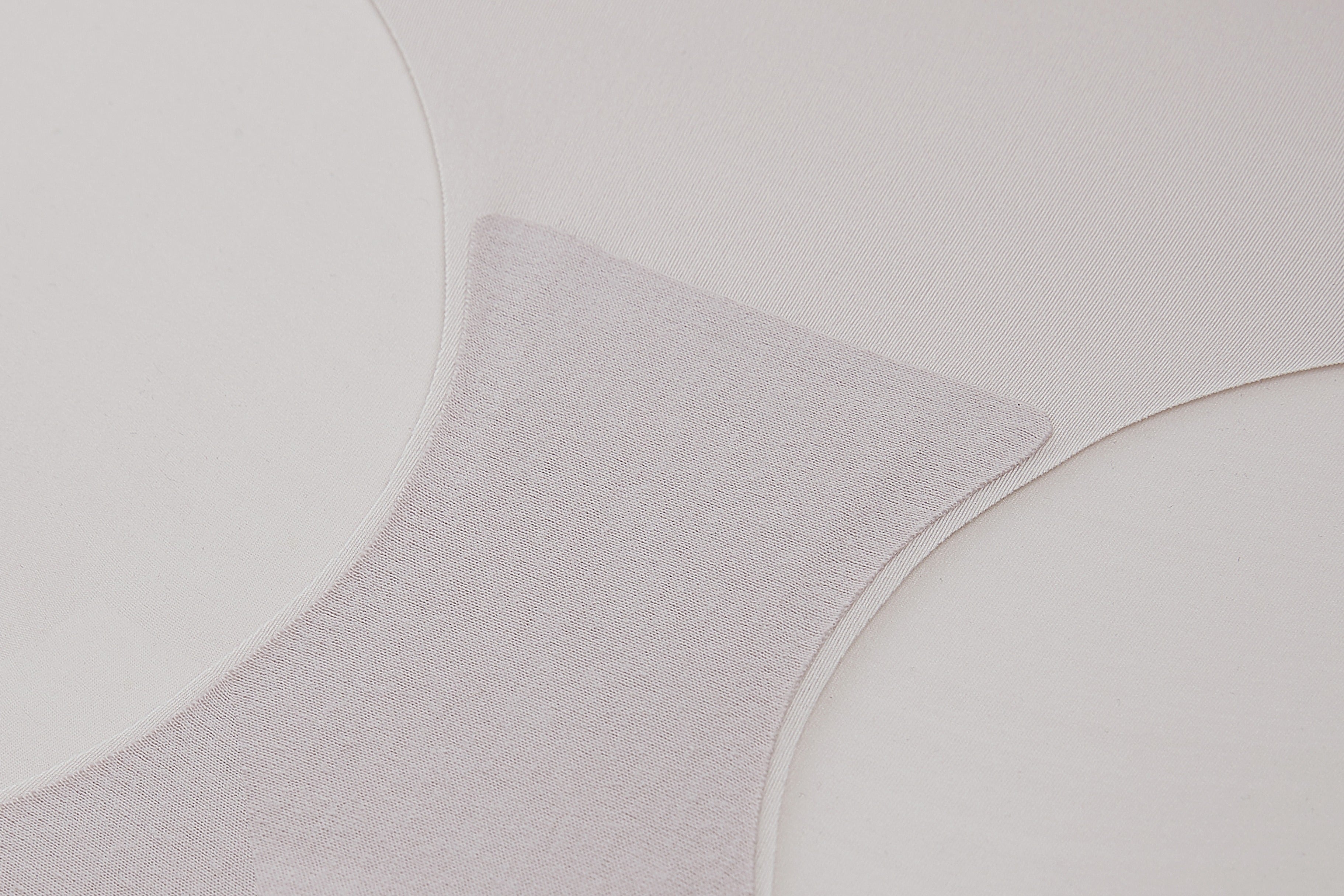 Gray textured fabric with circular patterns on a light gray background
