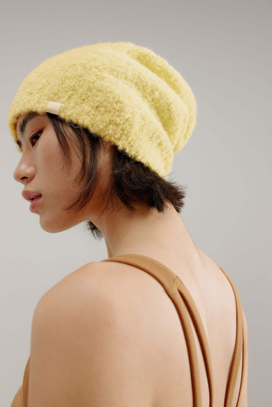 woman wearing a yellow beanie