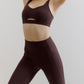 woman wearing a brown sports bra and leggings