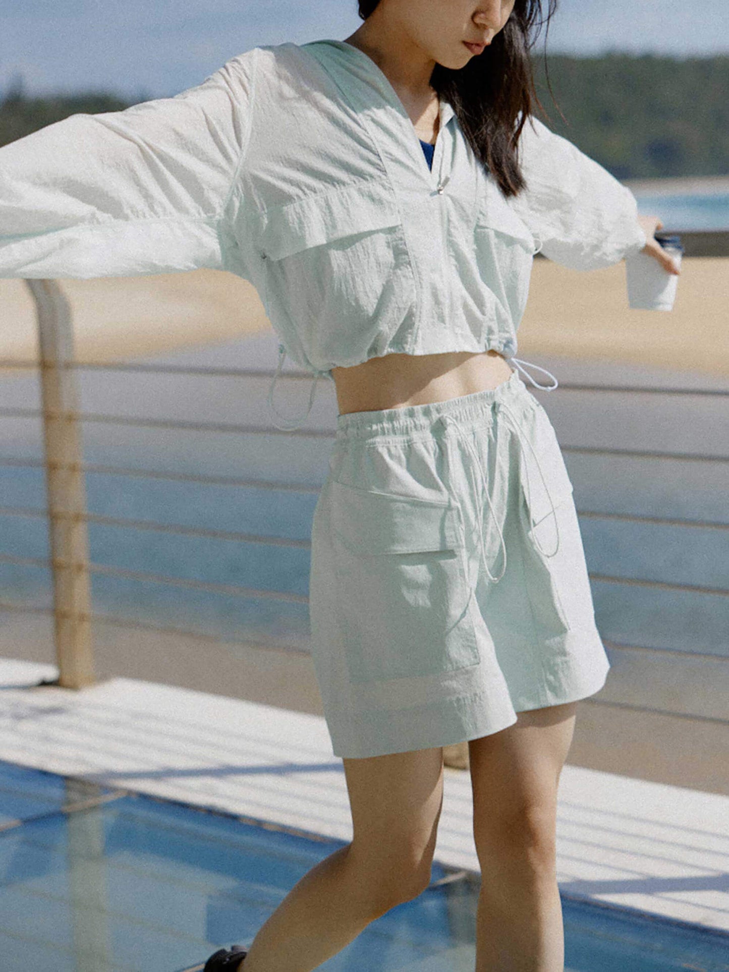 woman in blue jacket and shorts