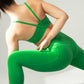 back of woman in green sports bra and leggings