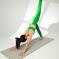 woman in green sports bra and leggings doing yoga