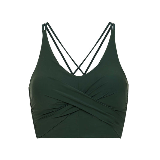 flat lay picture of a dark green color v-neck sports bra with ruched details and crossing back straps
