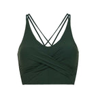flat lay picture of a dark green color v-neck sports bra with ruched details and crossing back straps