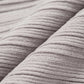 fabric detail of light grey shrug