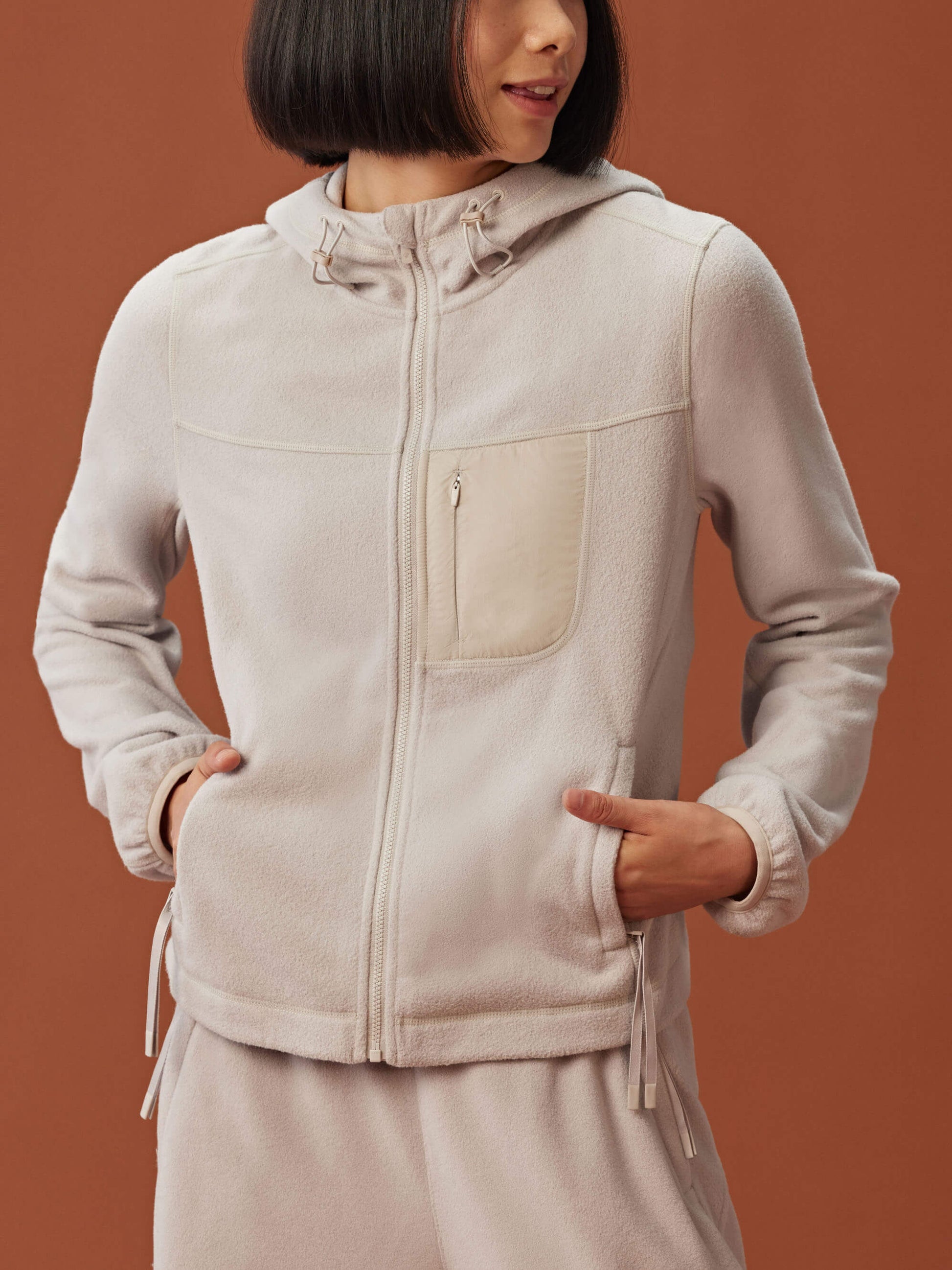 woman in beige zipped hooded fleece jacket