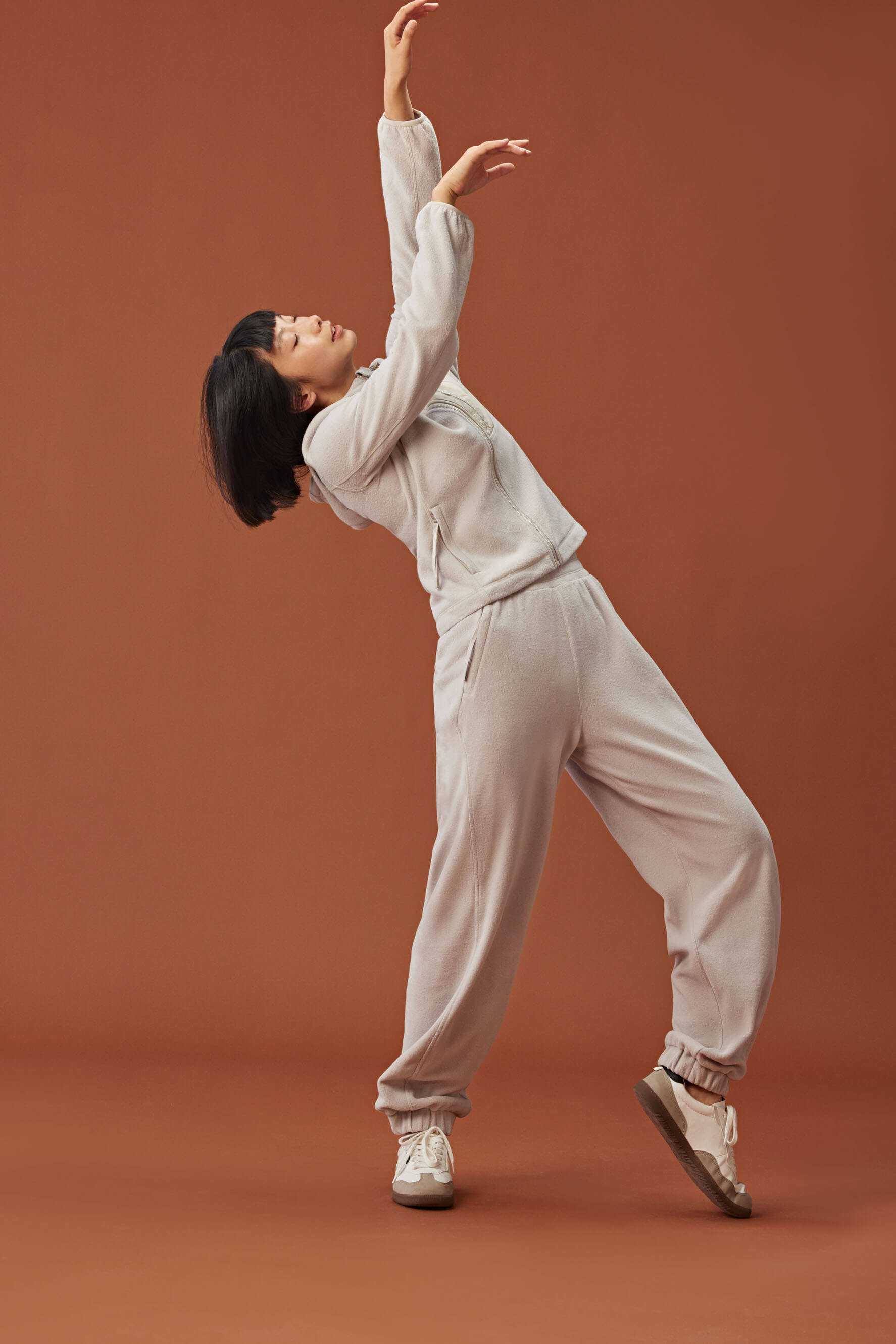 woman in beige zipped hooded fleece jacket and matching pants