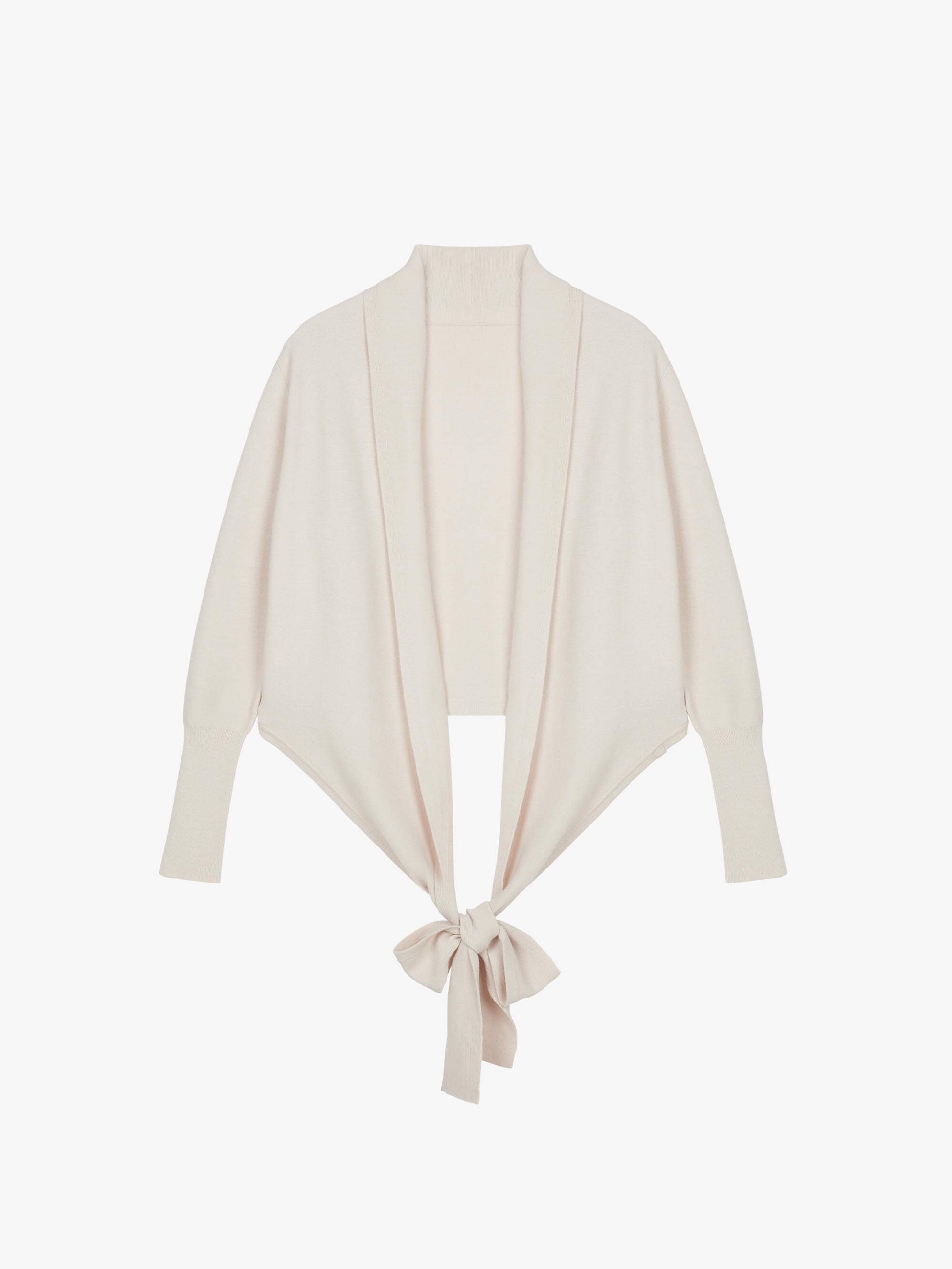 Flat lay image of knotted cream wrap sweater