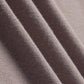 Close-up view of a taupe-colored knit fabric, showcasing its fine, textured weave and soft appearance.