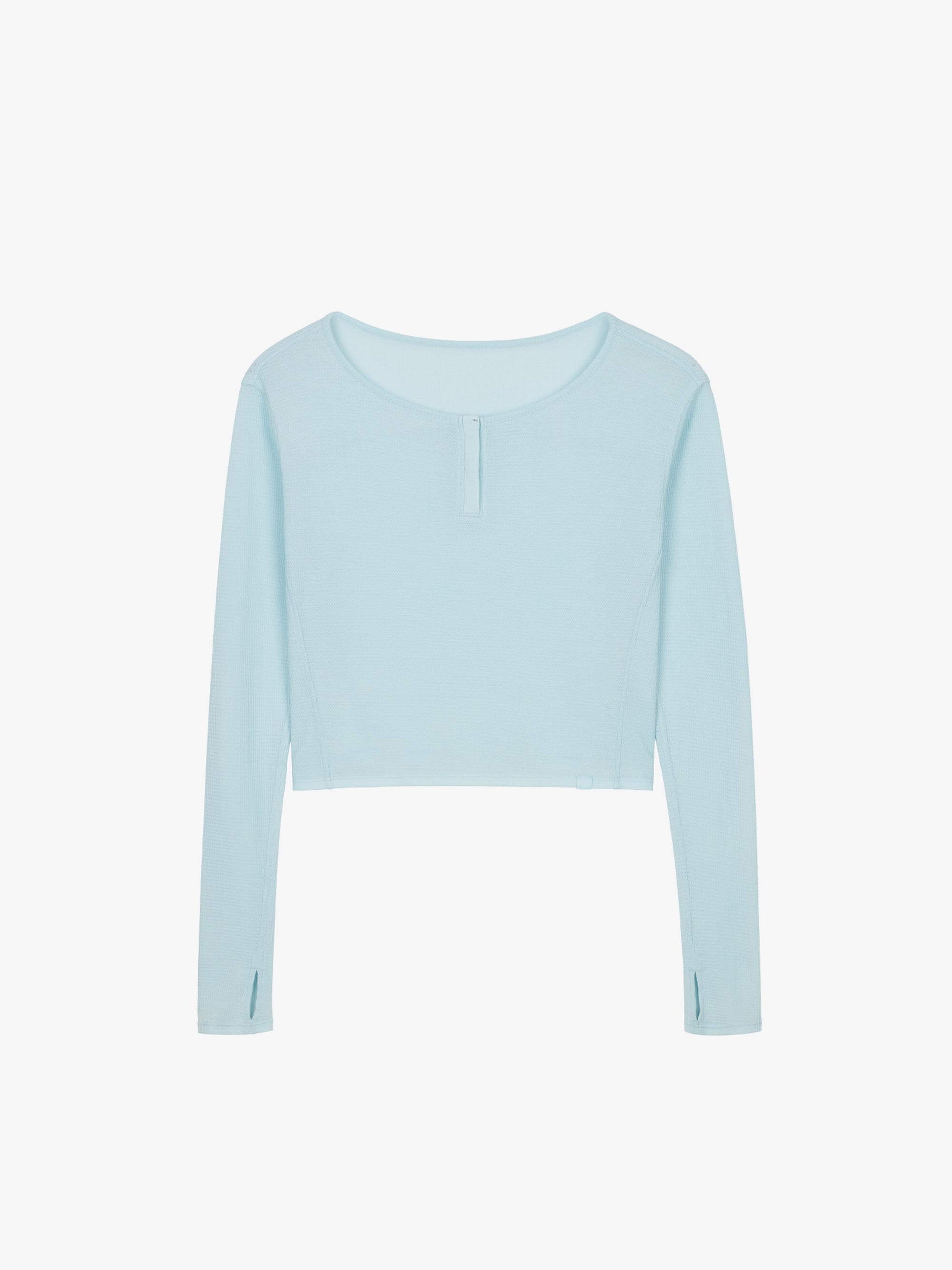 Flat lay of a light blue waffle long sleeve top, displayed flat against a white background.