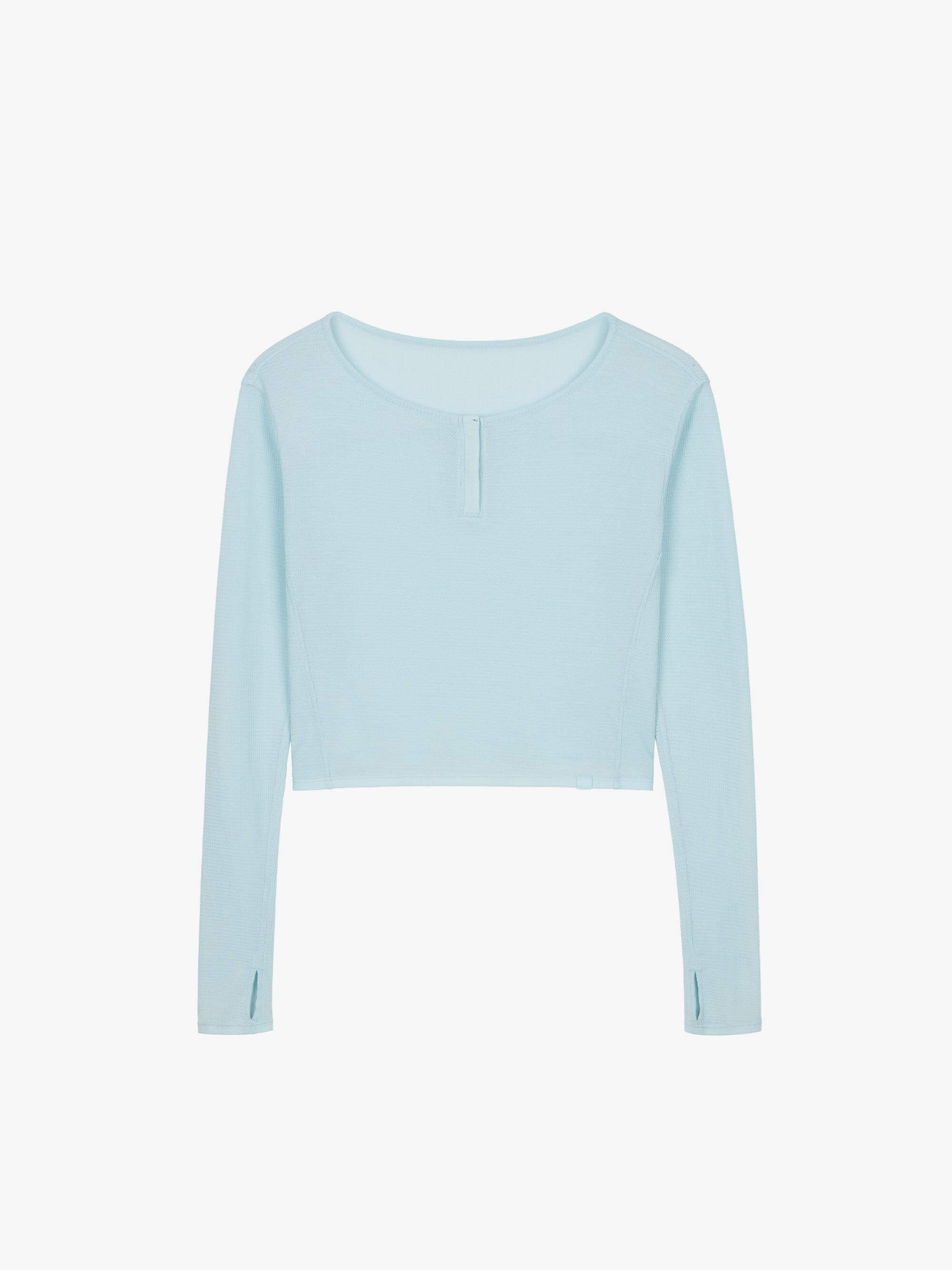 Flat lay of a light blue waffle long sleeve top, displayed flat against a white background.