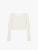 Flat lay of a white waffle long sleeve top, displayed flat against a white background