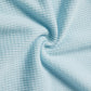  close-up view of light blue waffle-knit fabric, showcasing its textured grid pattern and soft, stretchy material.