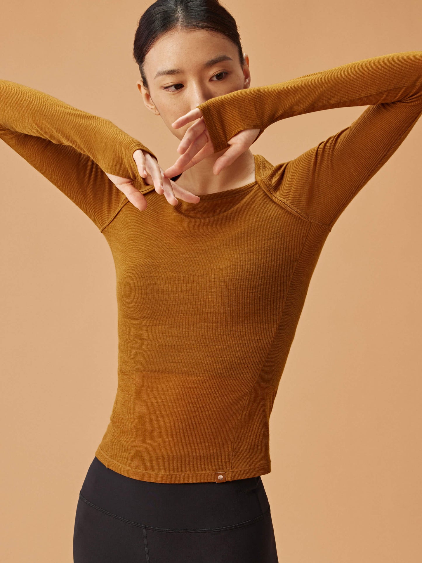 woman in golden brown wool top