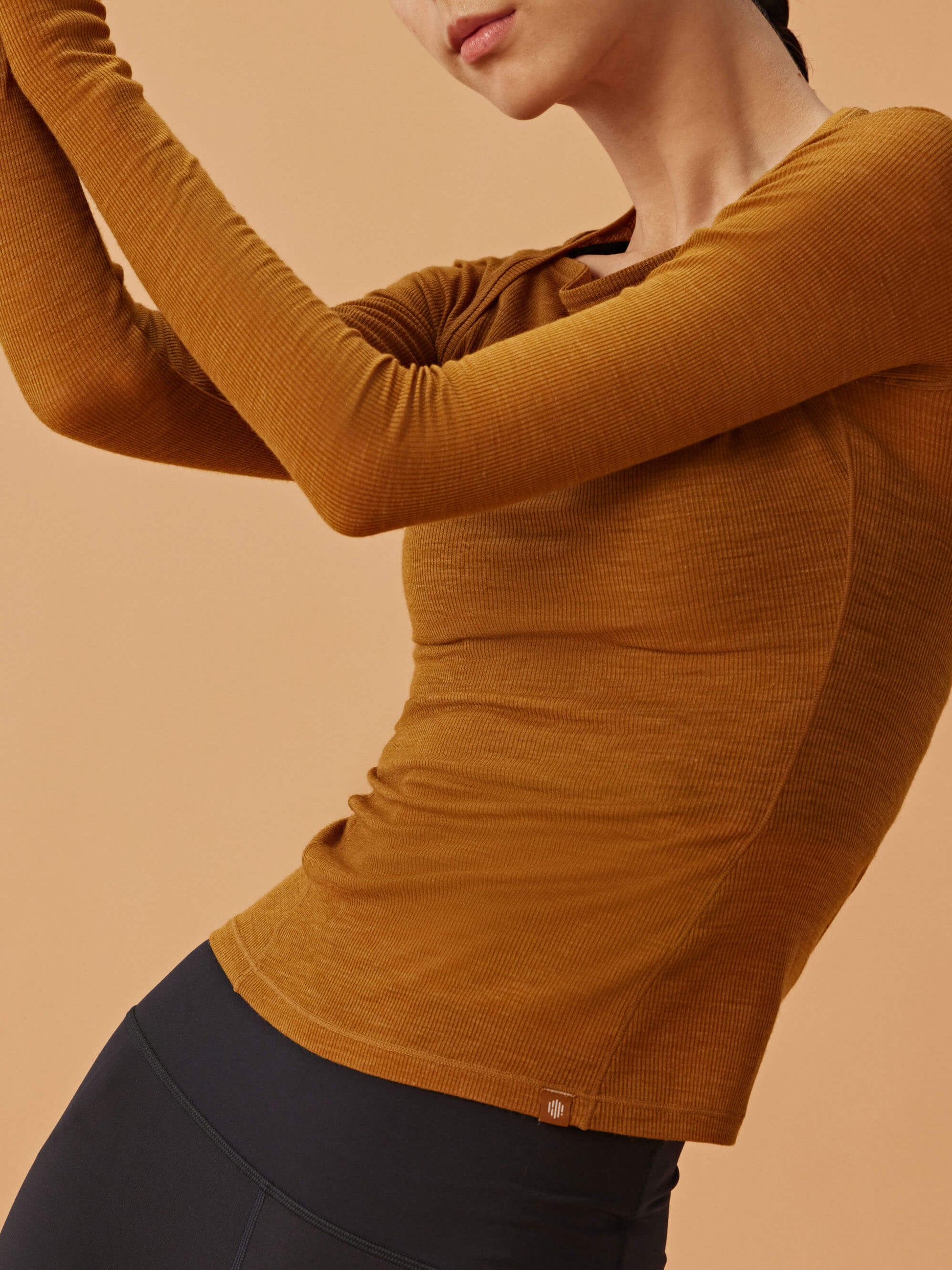 woman in golden brown wool top