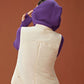 back of woman in purple knitted hoodie and white vest