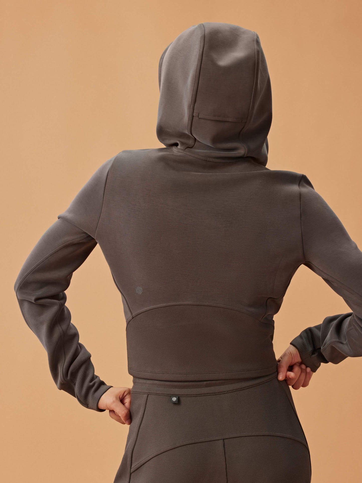 back of woman in dark gray hoodie and matching wide leg pants