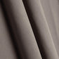 Close-up of beige fabric, showing smooth, flowing texture and soft folds.