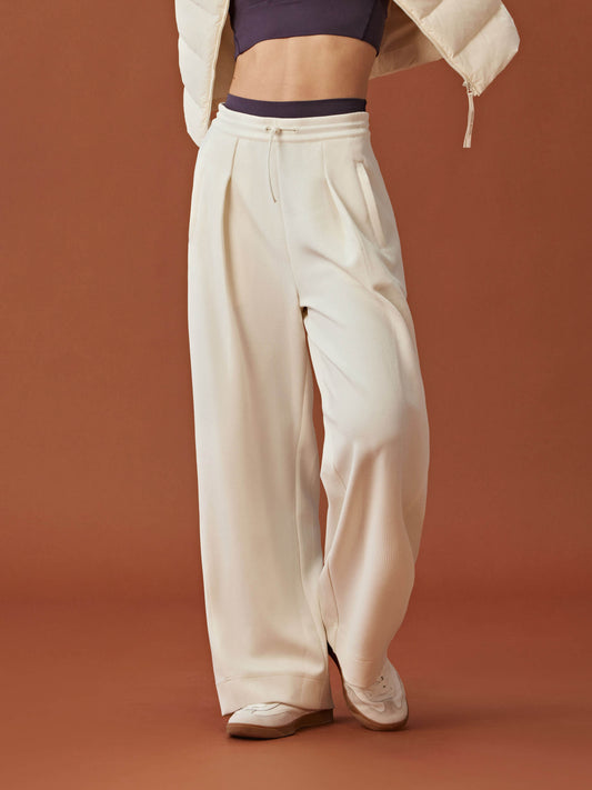 woman in white wide leg pants