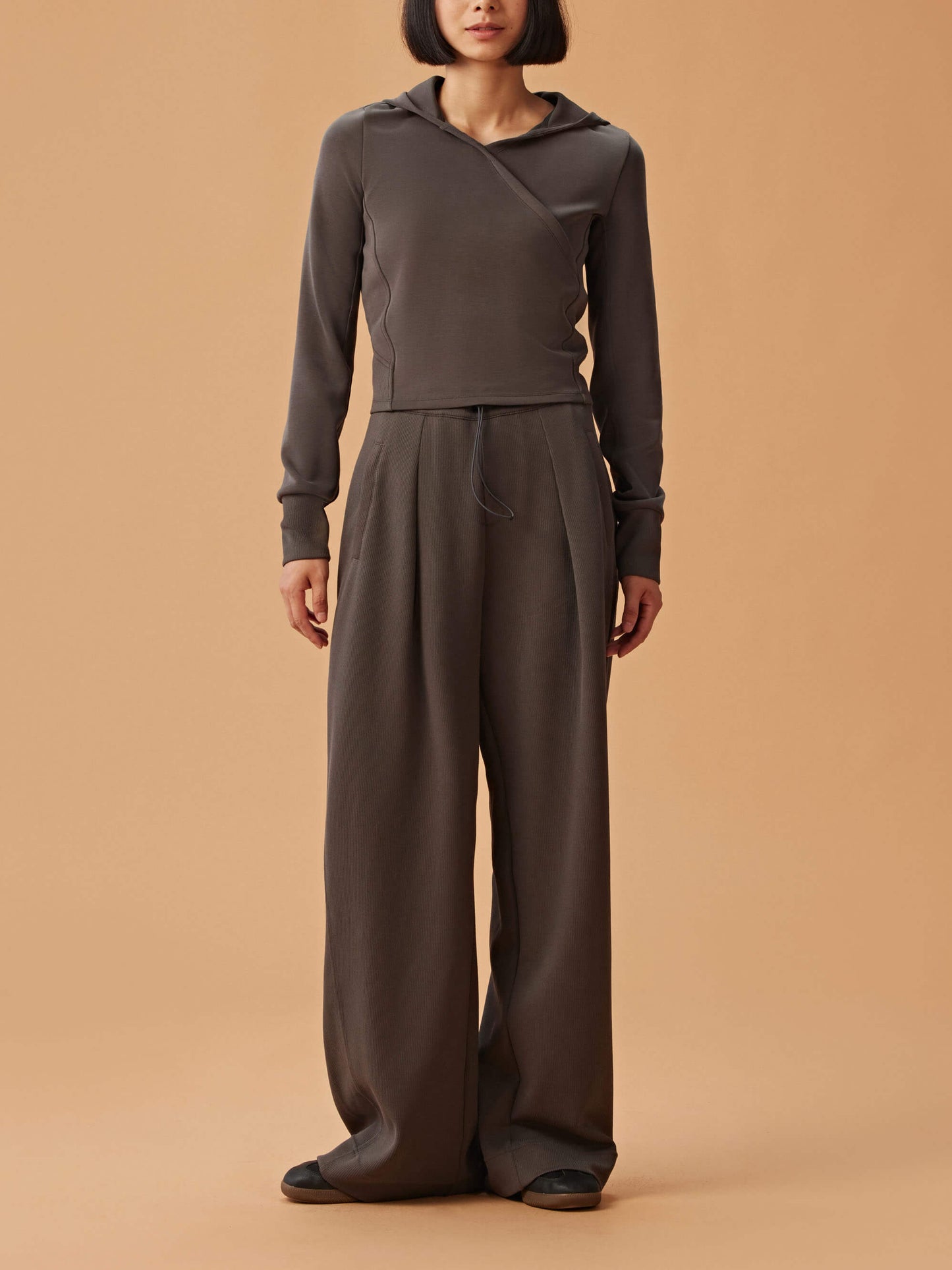 woman in dark gray hoodie and matching wide leg pants