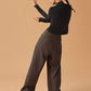 back of woman in black long sleeve top and dark gray wide leg pants