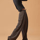 woman in black long sleeve top and dark gray wide leg pants