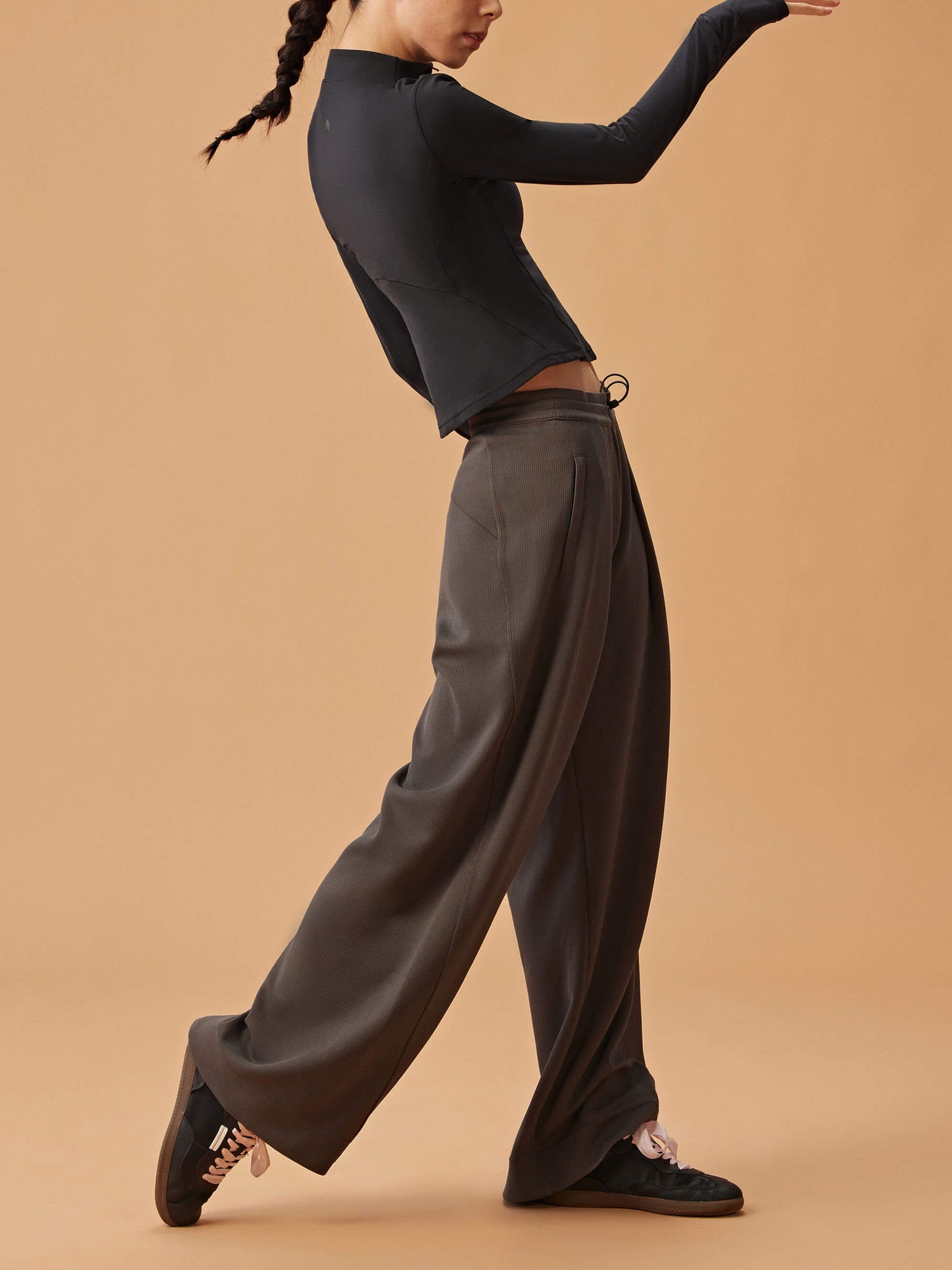 woman in black long sleeve top and dark gray wide leg pants