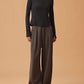 woman in black long sleeve top and dark gray wide leg pants