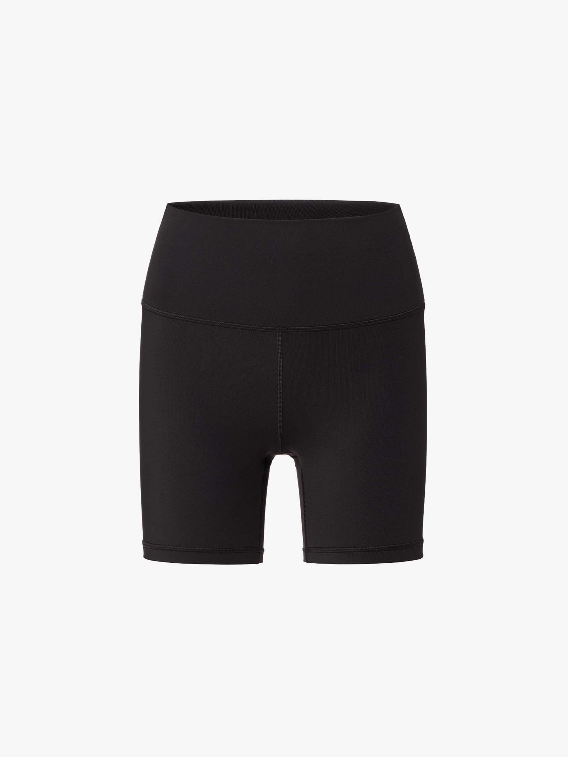 Flat lay of black high-waisted biker shorts displayed flat against a white background.