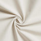 Close-up of beige fabric twisted in a spiral, showcasing its texture and weave.