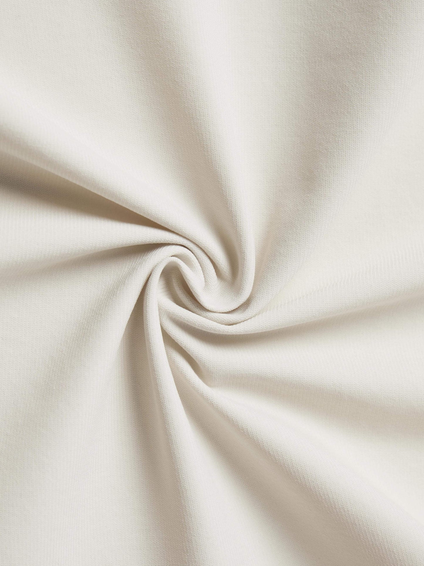 Close-up of beige fabric twisted in a spiral, showcasing its texture and weave.