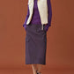 woman in purple hoodie, white vest and purple midi skirt.