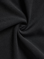 Close-up of black fabric, twisted to show the softness.
