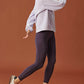 woman in light purple fleece sweatshirt and dark purple leggings