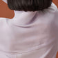 back of woman in light purple fleece sweatshirt, showcasing the NEIWAI ACTIVE stitch on the back.